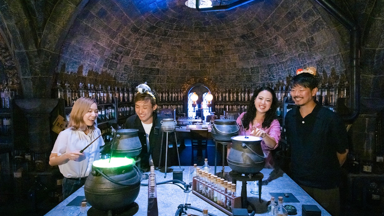 People crafting potions in a Hogwarts-themed room at Warner Bros. Studio Tour Tokyo.