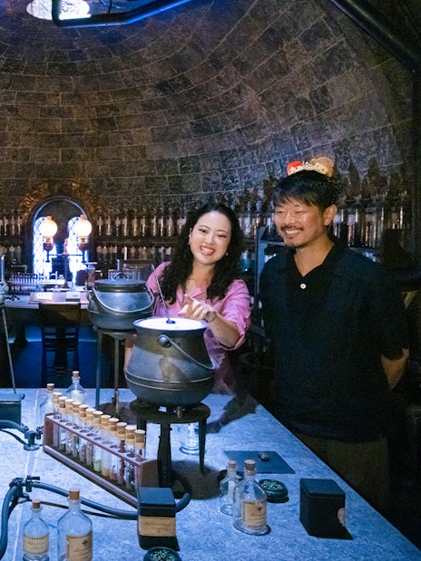 People crafting potions in a Hogwarts-themed room at Warner Bros. Studio Tour Tokyo.