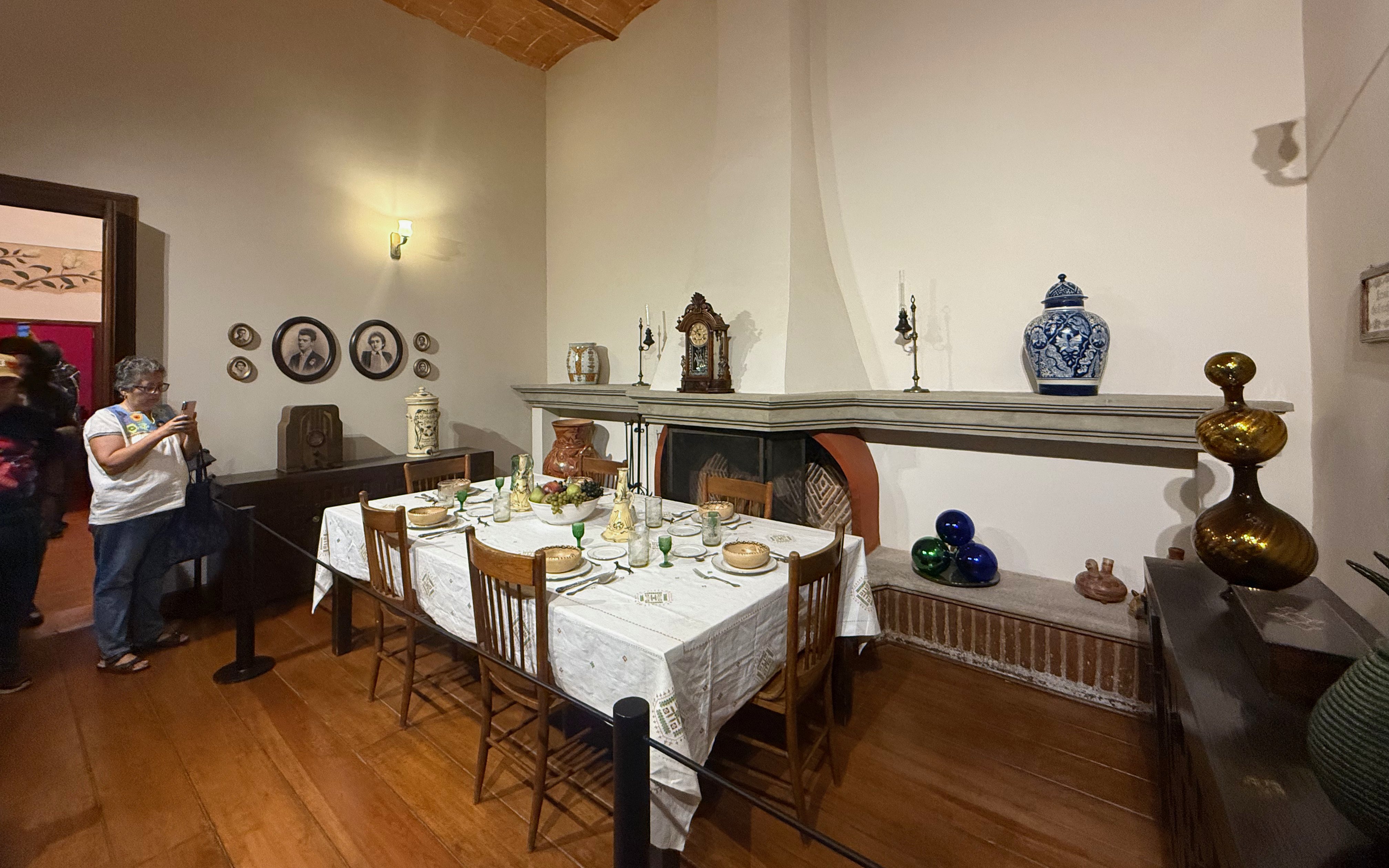 Dining room at Frida Kahlo Museum, La Casa Roja, with set table and decorative items.