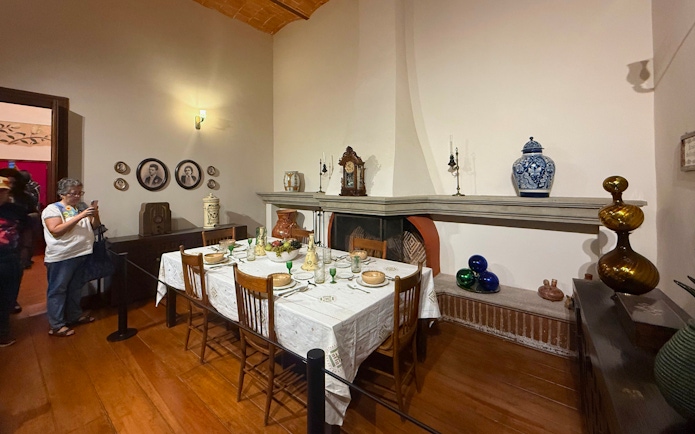 Dining room at Frida Kahlo Museum, La Casa Roja, with set table and decorative items.