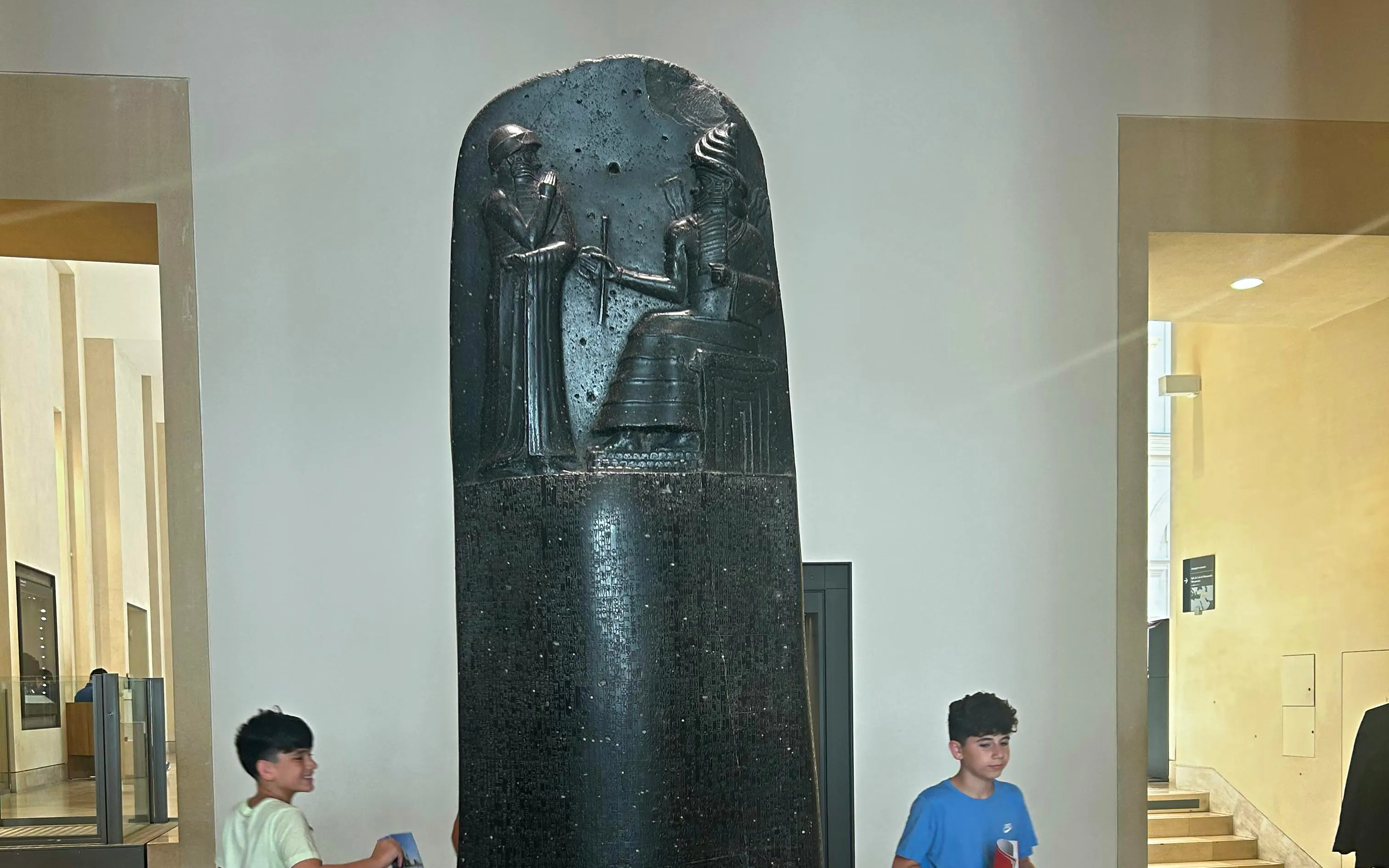 Code of Hammurabi stele displayed in a museum setting.