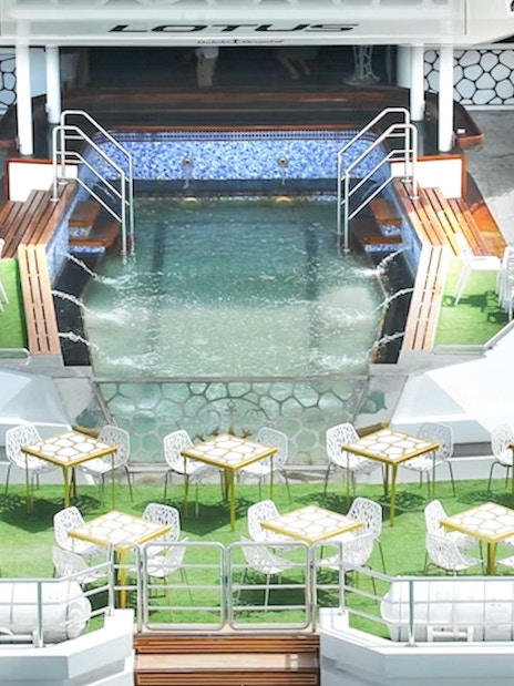 Lotus Mega Yacht deck with dining tables and pool, Dubai Marina cruise.