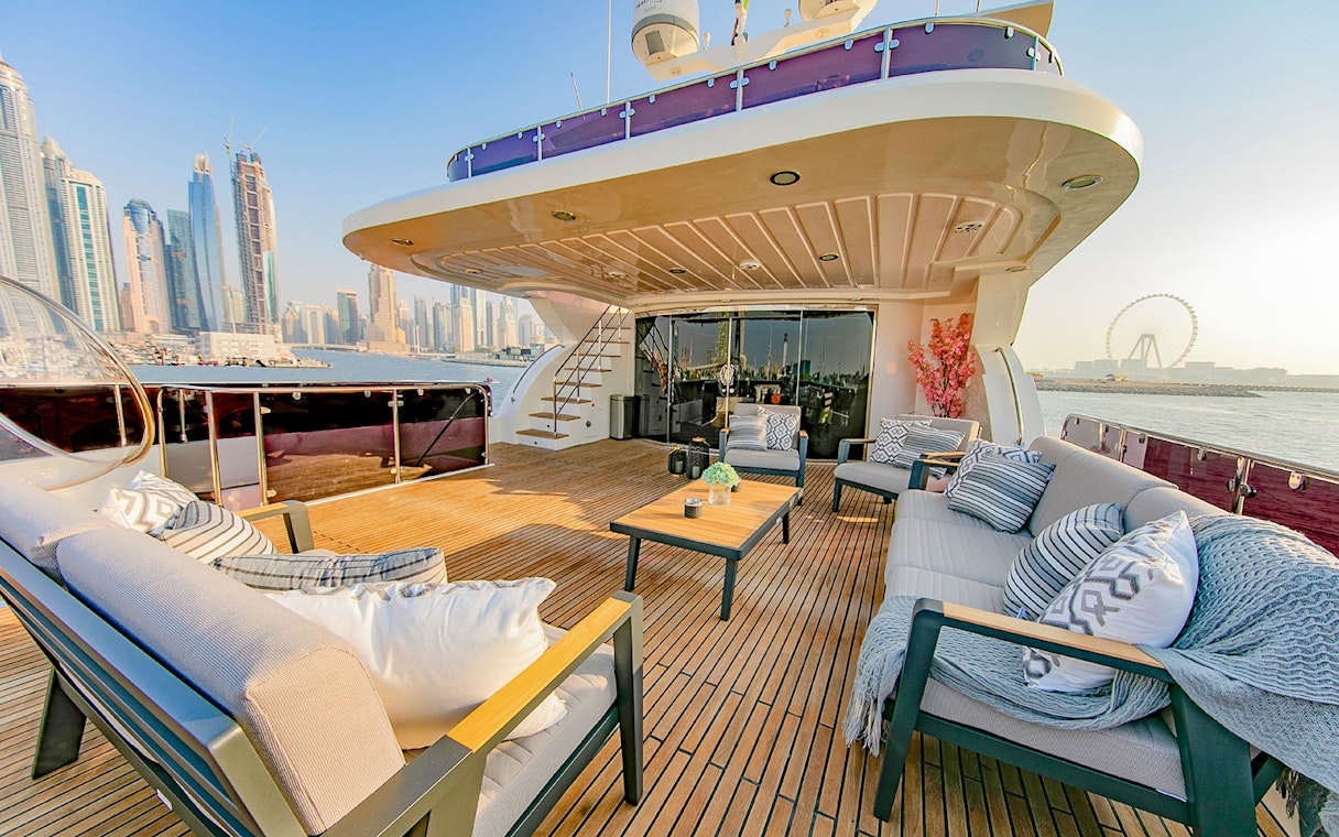 Superyacht TriDeck cruise deck with seating area overlooking Dubai skyline.