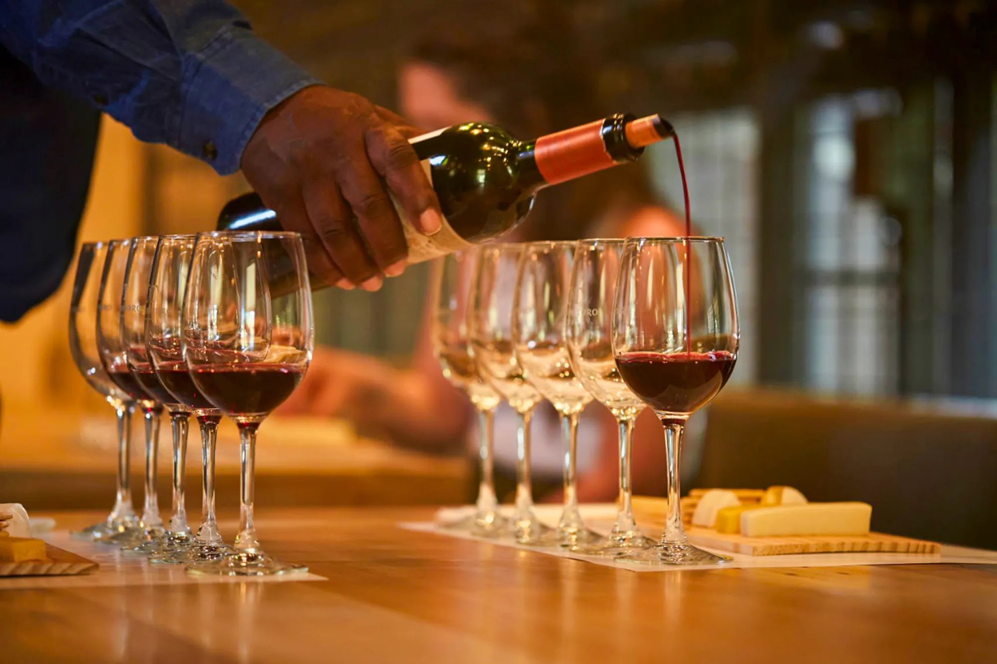 Wine being poured into glasses at Concha y Toro Winery, Santiago.
