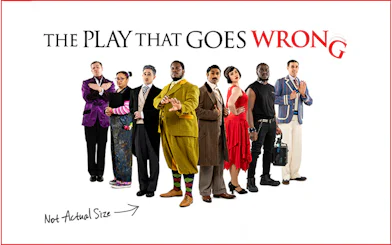 Cast of "The Play That Goes Wrong" in various costumes standing in a line.