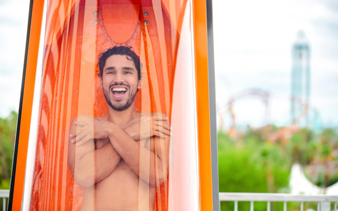 Man inside a water slide capsule at Knott's Soak City.