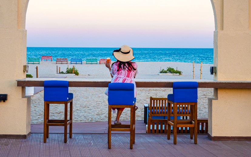 Woman enjoying ocean view at Al Majles Resort.