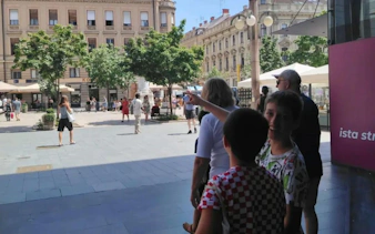People exploring a lively square in Zagreb, part of the Zagreb Essentials Slavic Myths self-guided tour.