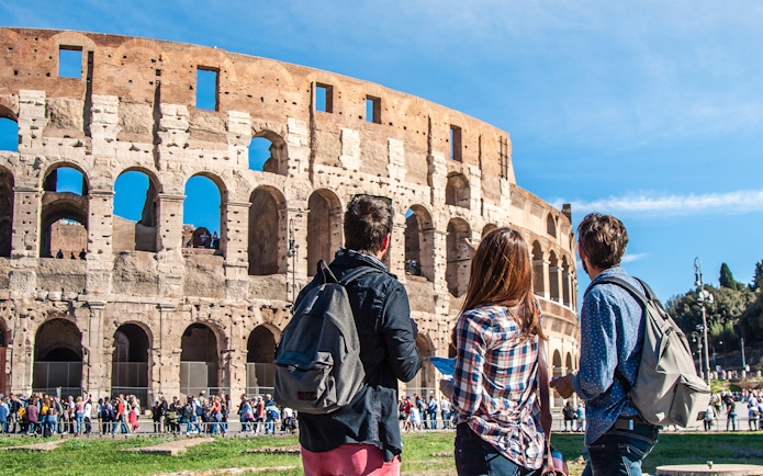 Tourists with a guide at the Colosseum in Rome, Italy.