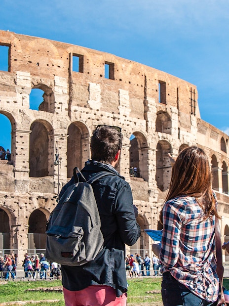 Tourists with a guide at the Colosseum in Rome, Italy.