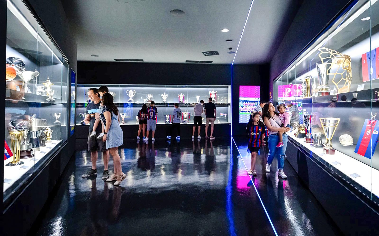 Visitors viewing trophies at the Spotify Camp Nou Barça Museum in Barcelona.