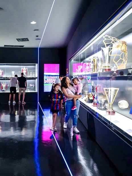 Visitors viewing trophies at the Spotify Camp Nou Barça Museum in Barcelona.