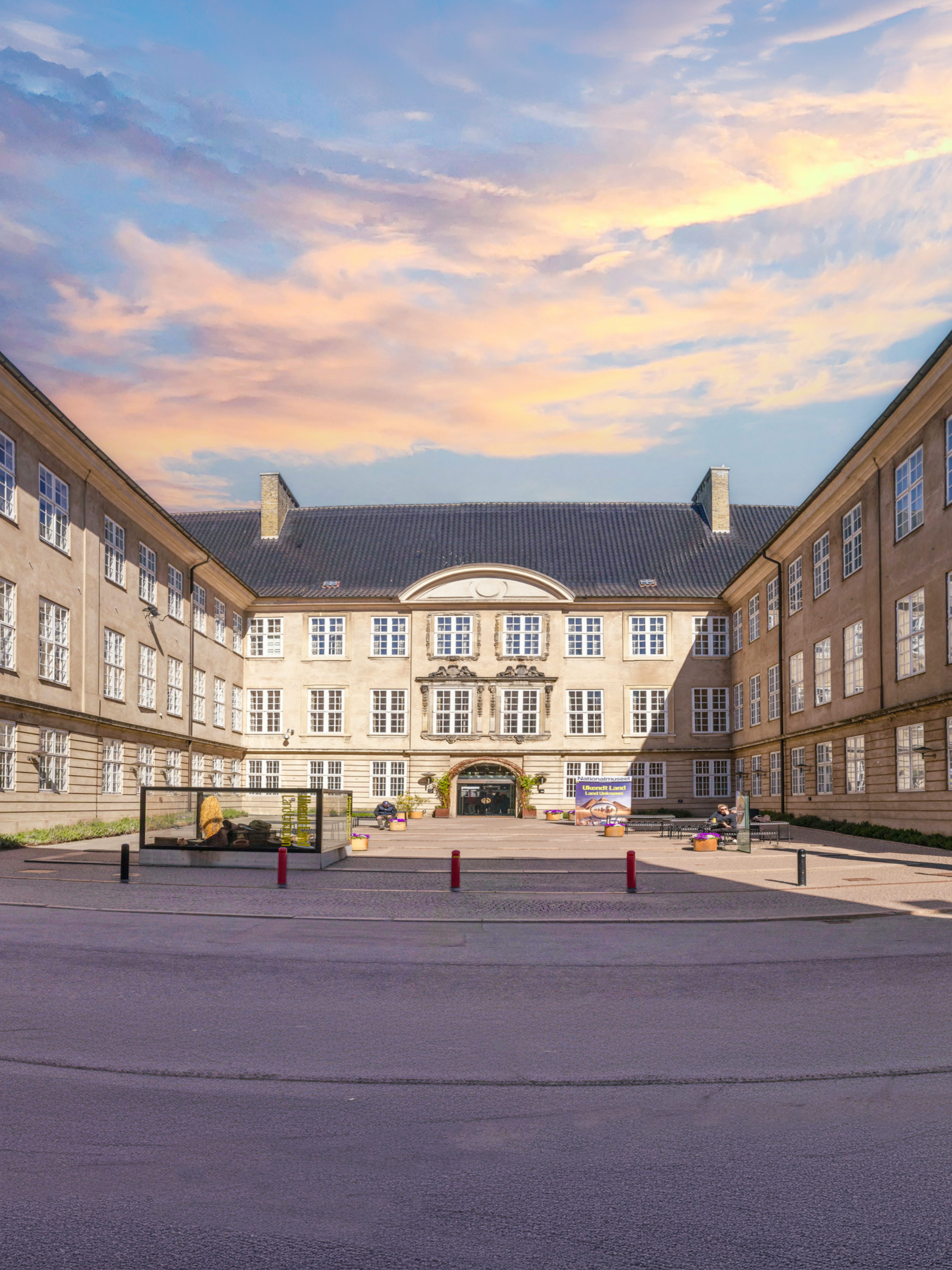 Exterior view of The National Museum of Denmark in Copenhagen with banners and courtyard.