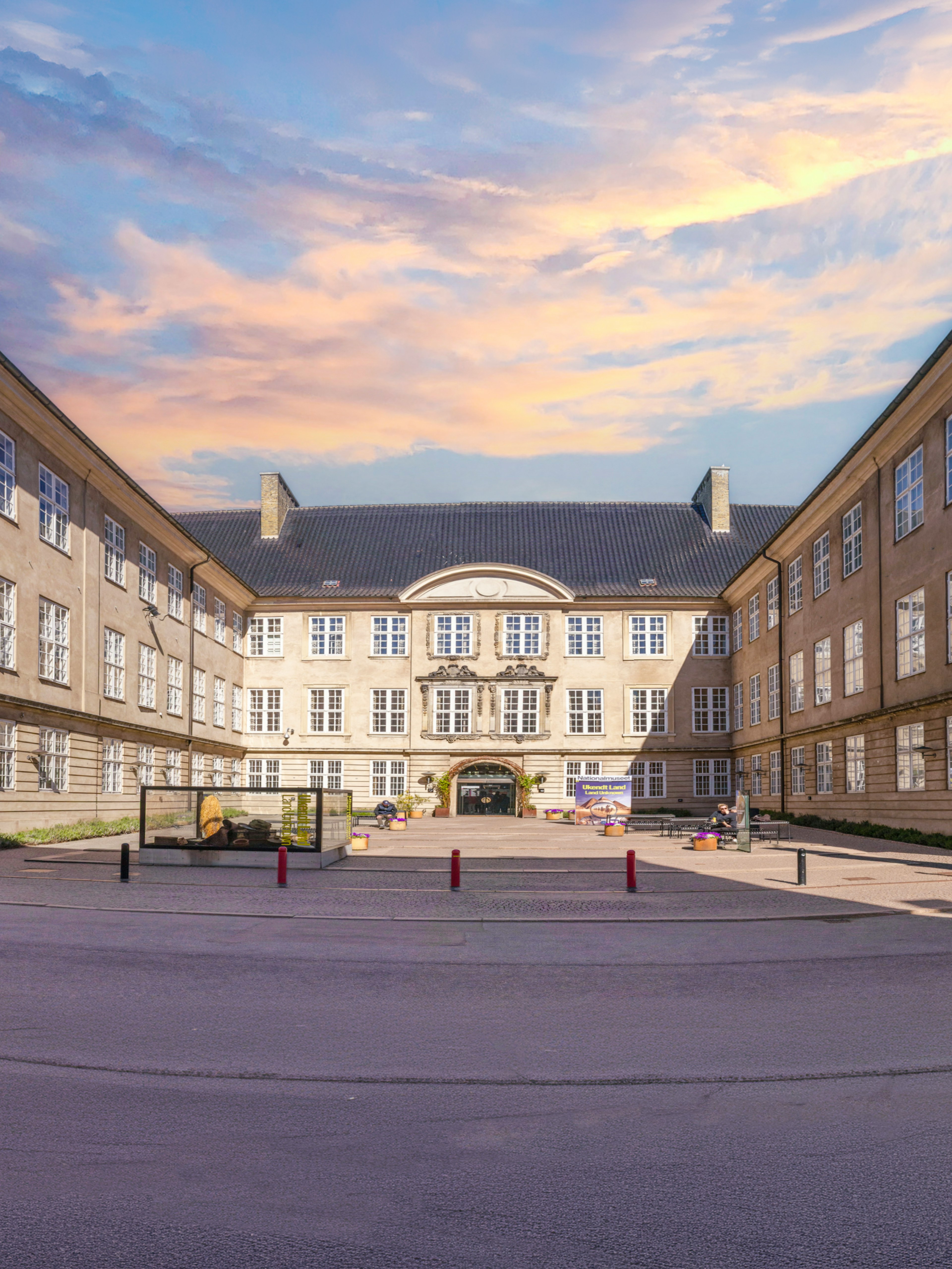 Exterior view of The National Museum of Denmark in Copenhagen with banners and courtyard.
