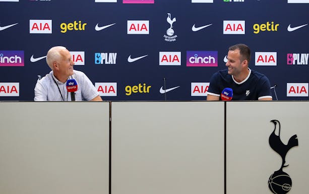 Press conference at Tottenham Hotspur Stadium with two speakers at a table.