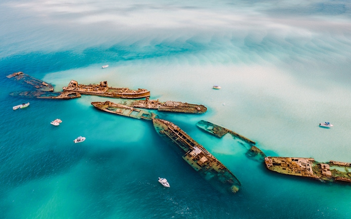 Aerial view of Tangalooma wrecks in turquoise waters, Moreton Island, Australia.