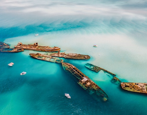 Aerial view of Tangalooma wrecks in turquoise waters, Moreton Island, Australia.