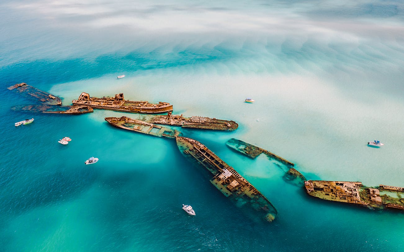 Aerial view of Tangalooma wrecks in turquoise waters, Moreton Island, Australia.