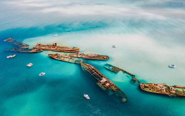 Aerial view of Tangalooma wrecks in turquoise waters, Moreton Island, Australia.