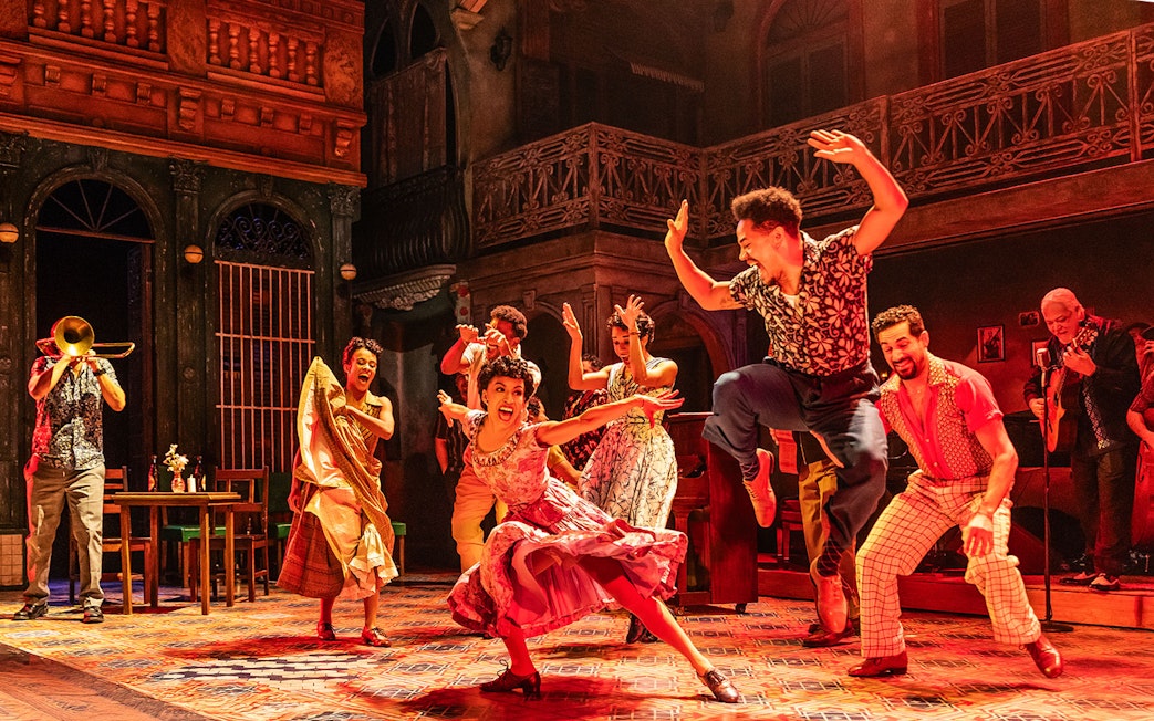 Performers dancing energetically at Buena Vista Social Club show.