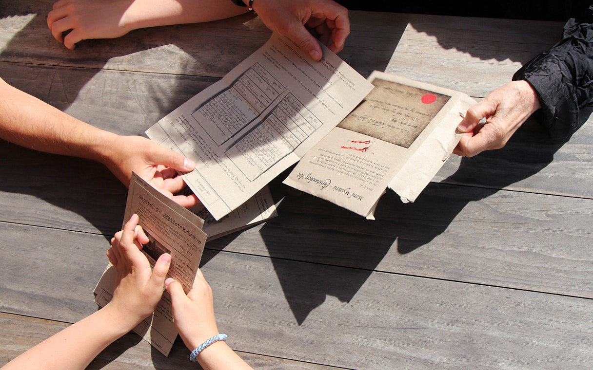 Participants examining clues for Murder Mystery at Round Tower, Copenhagen.
