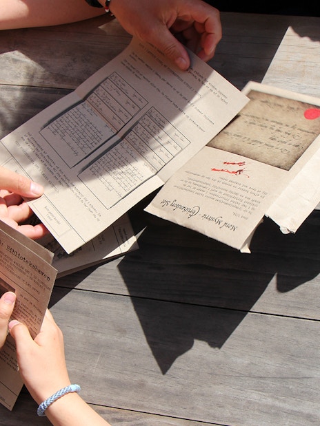 Participants examining clues for Murder Mystery at Round Tower, Copenhagen.