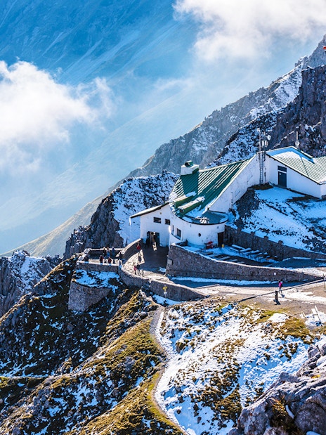 Hafelekar mountain station in Austria with snowy peaks and visitors exploring.