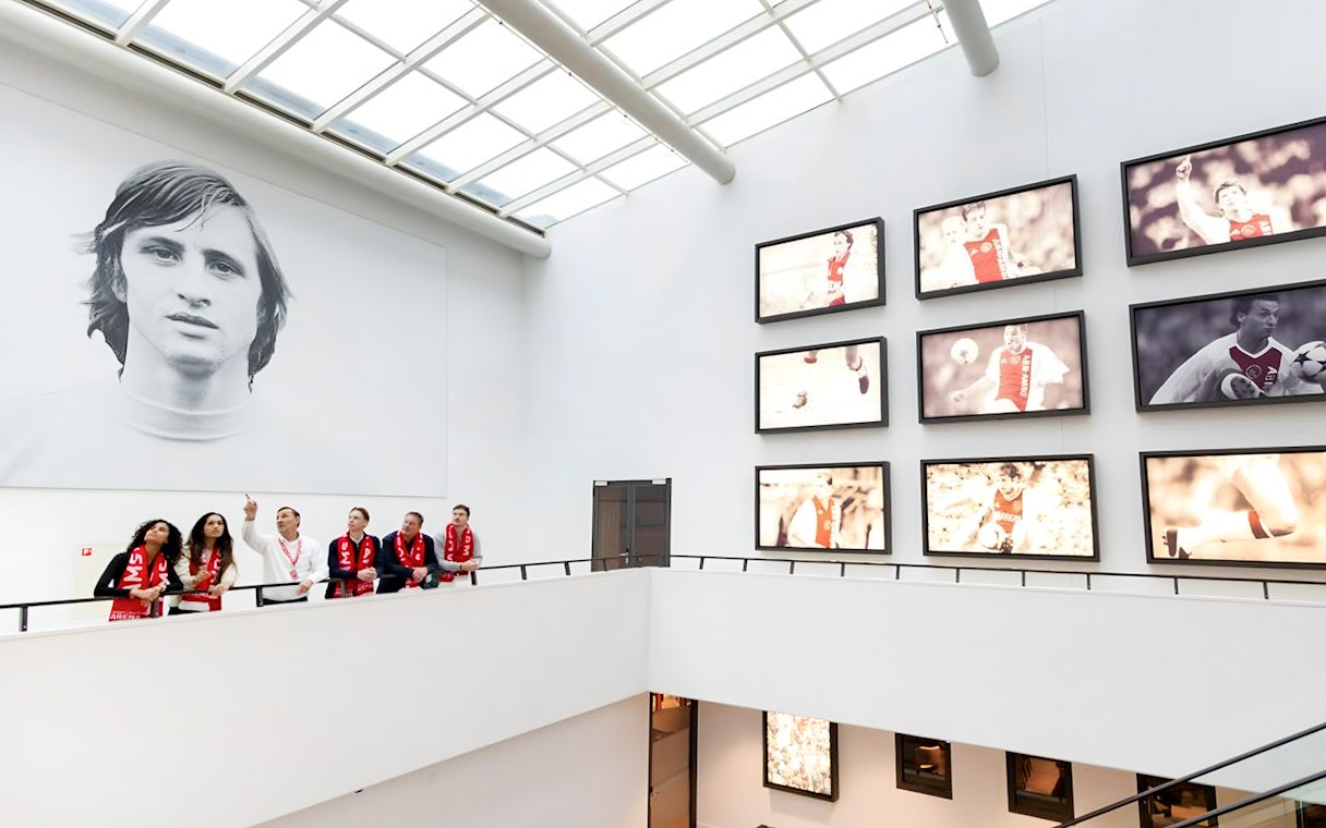 Visitors on a VIP tour at Johan Cruijff ArenA, Amsterdam, viewing football memorabilia.
