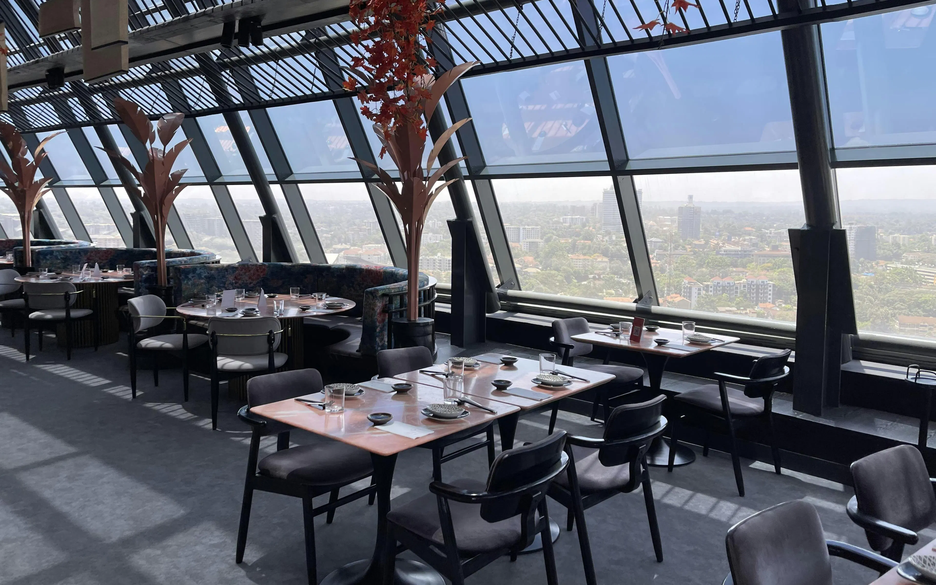 Skyview restaurant interior with panoramic Nairobi cityscape.