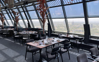 Skyview restaurant interior with panoramic Nairobi cityscape.
