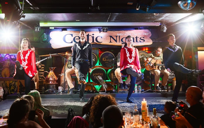 Dancers performing traditional Irish dance at Celtic Nights show in Dublin.