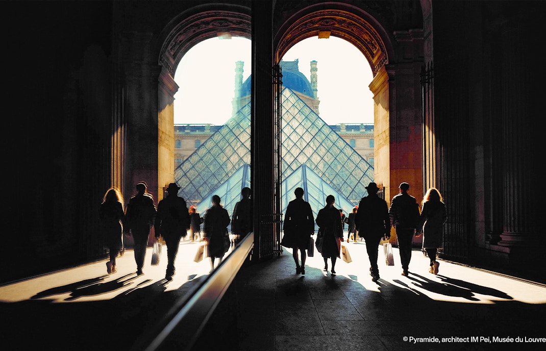 Louvre Museum Richelieu Passage entrance in Paris with visitors exploring the historic architecture.