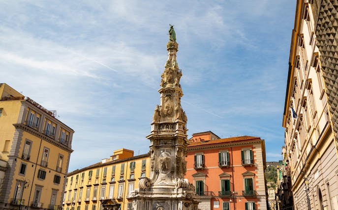 Quartieri Spagnoli monument with surrounding colorful buildings in Naples.