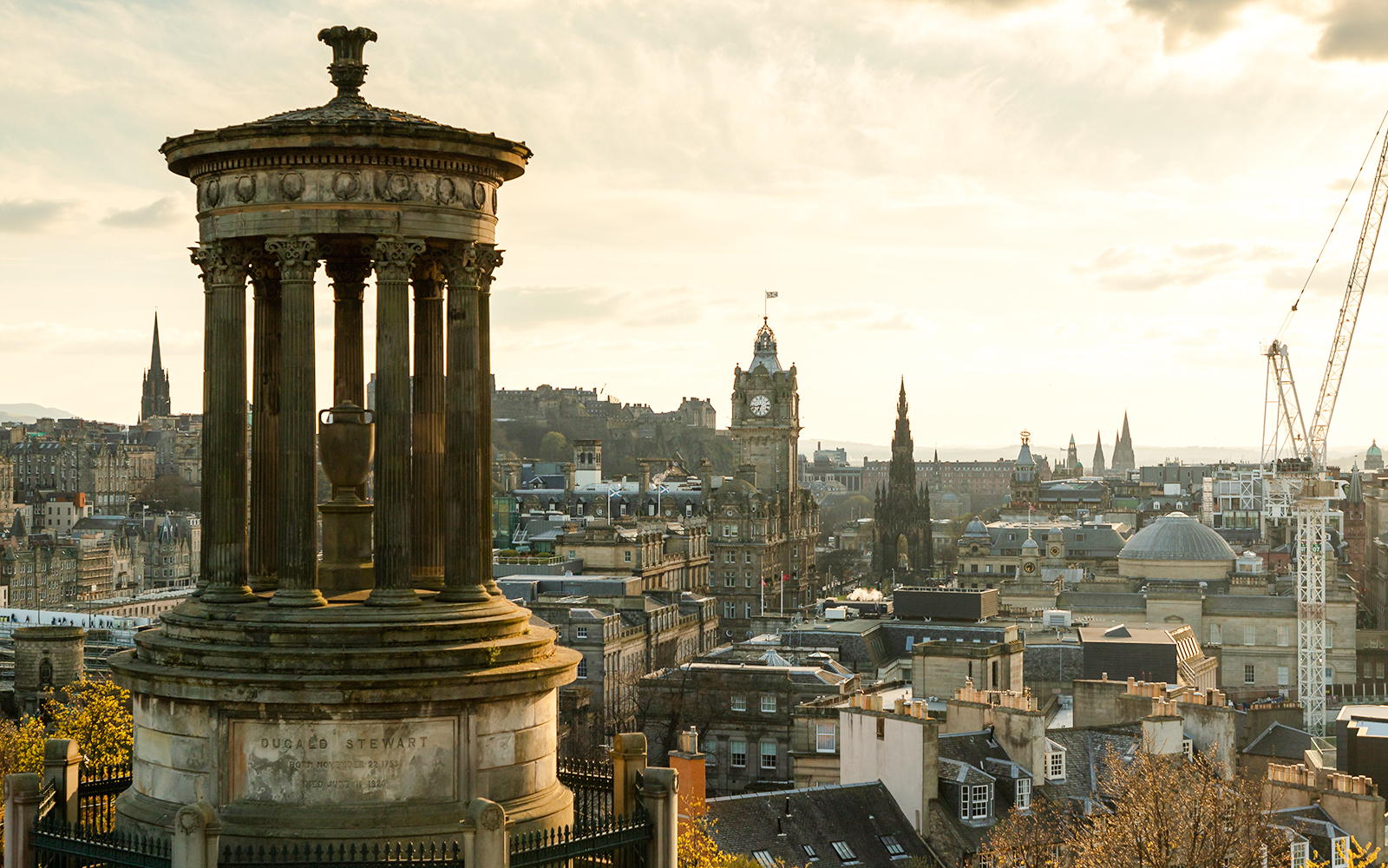 Calton Hill view of Edinburgh skyline with Dugald Stewart Monument, Scotland.