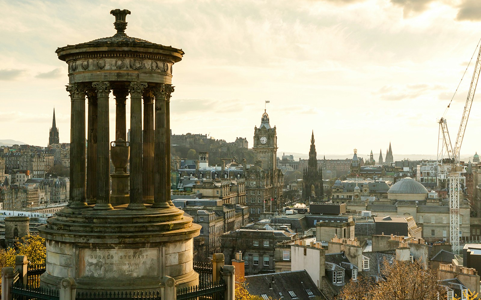 Calton Hill view of Edinburgh skyline with Dugald Stewart Monument, Scotland.