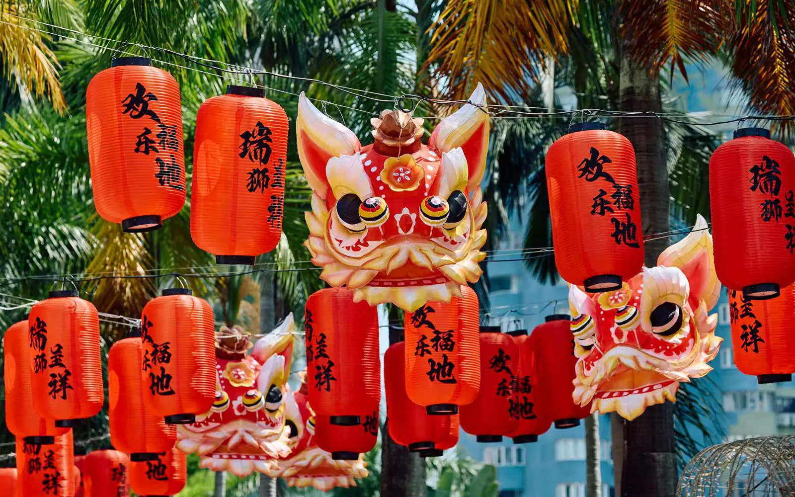 Red lanterns and lion masks at Window of the World theme park, Shenzhen, China.