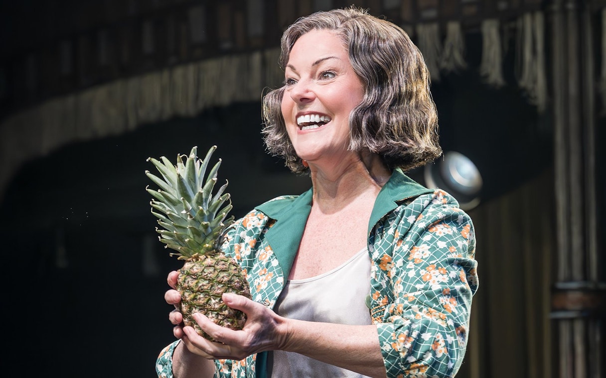 Performer holding a pineapple during Cabaret Westend show.