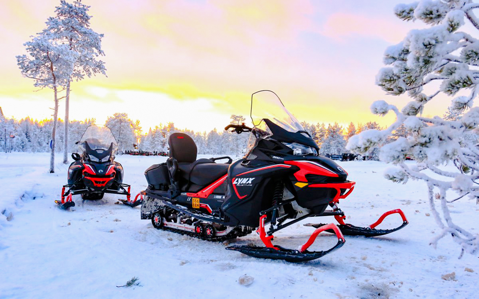 Snowmobiles parked on snowy landscape during 1-Hour Snowmobile Safari Adventure in Rovaniemi.