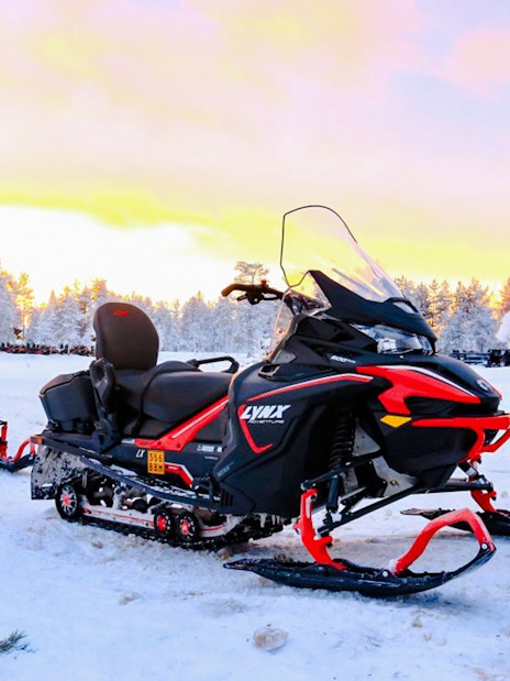Snowmobiles parked on snowy landscape during 1-Hour Snowmobile Safari Adventure in Rovaniemi.