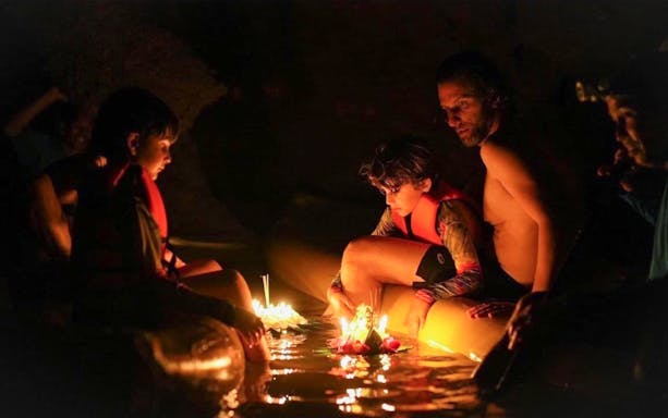 Canoeing in a cave with floating candles during John Gray's Sea Canoe tour in Phuket.