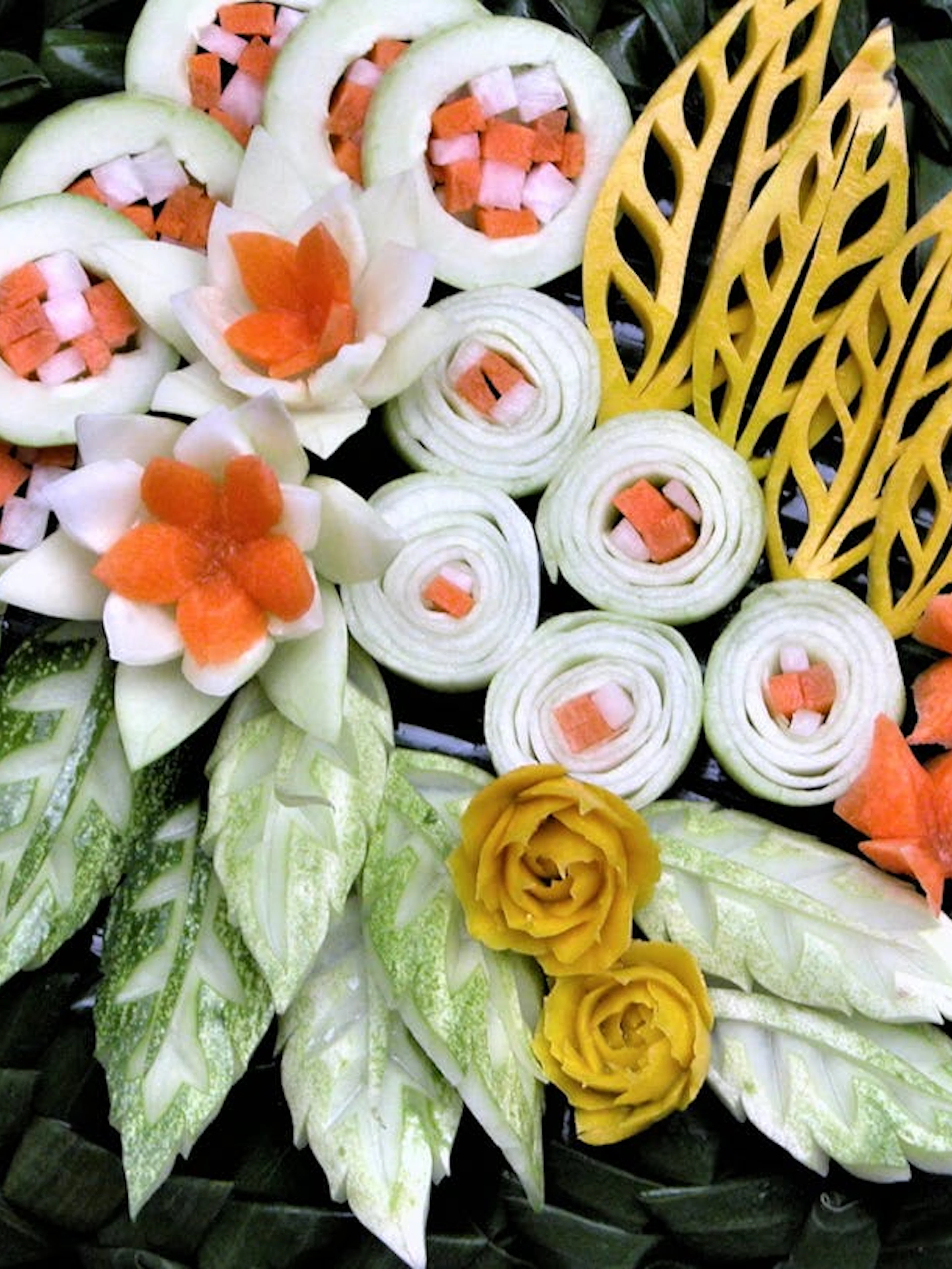 Thai fruit and vegetable carvings with intricate floral designs and leaf patterns.