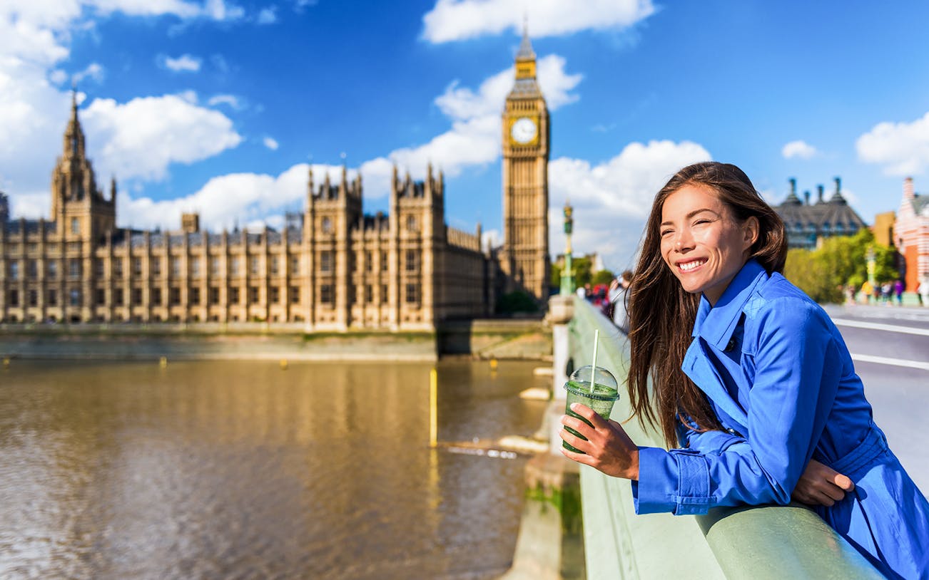 Person enjoying view of Big Ben and Houses of Parliament during Westminster walking tour, London.