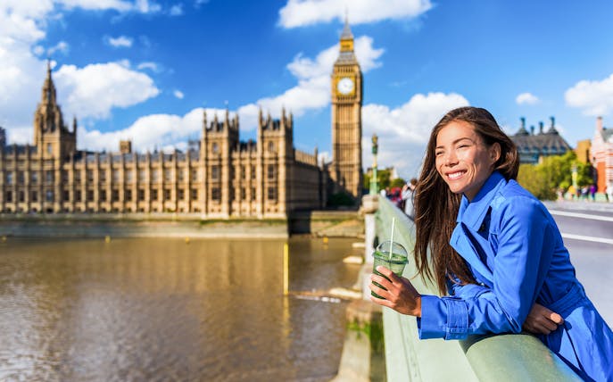 Person enjoying view of Big Ben and Houses of Parliament during Westminster walking tour, London.