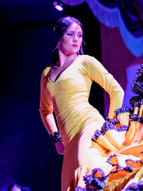 Flamenco dancer in yellow dress performing at Only Flamenco, Seville.