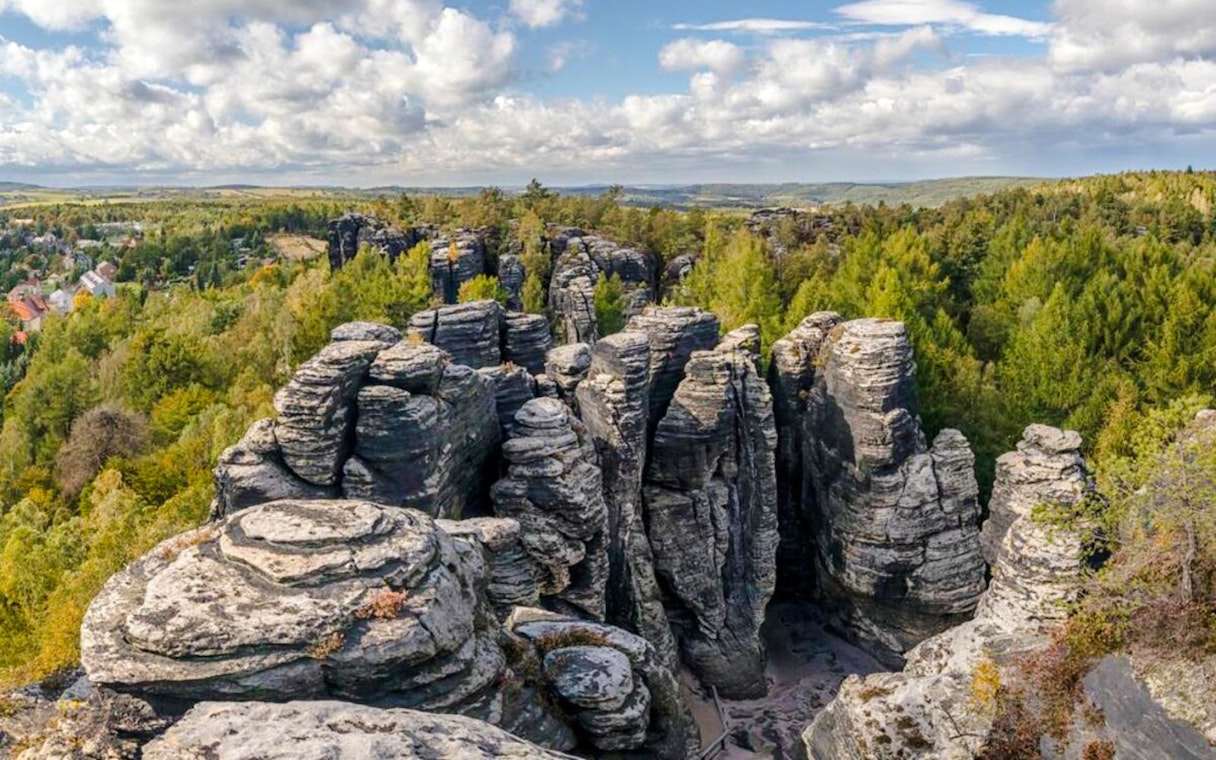 Elbe canyon rock formations in Bohemian Switzerland National Park, surrounded by forest.