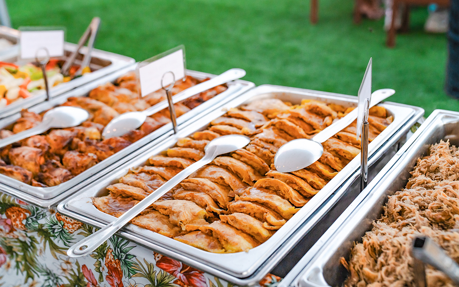 Mauka Warriors Luau guests enjoying traditional Hawaiian buffet with dancers performing in Honolulu, Hawaii.