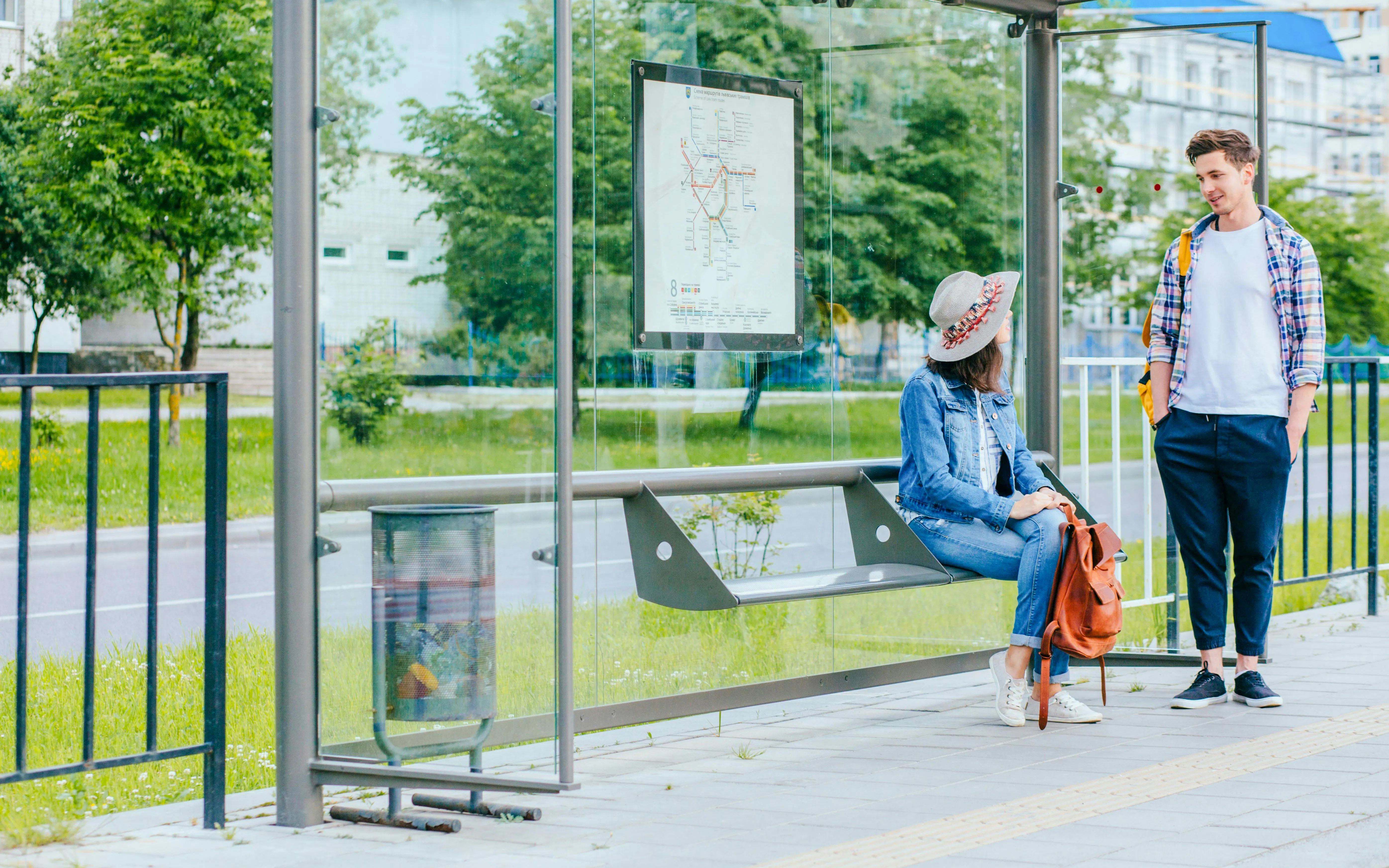 Couple talking at a bus stop in Cannes, France.