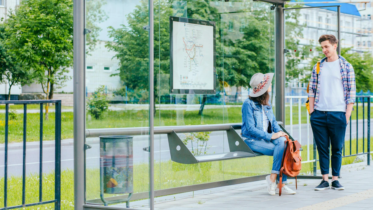 Couple talking at a bus stop in Cannes, France.