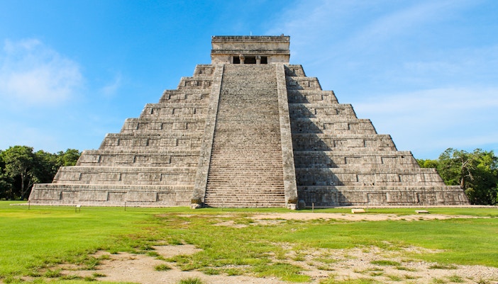 Chichen Itza pyramid under a clear blue sky in Mexico.