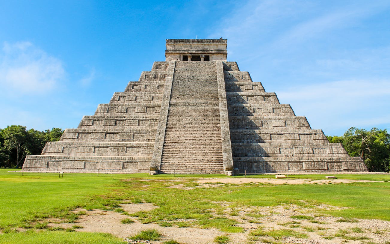 Chichen Itza pyramid under a clear blue sky in Mexico.